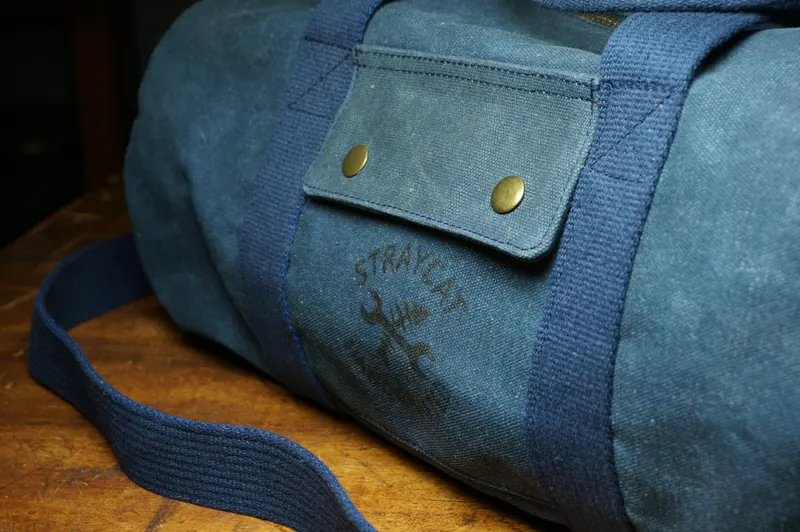 Detail: outside pocket with press stud and logo.