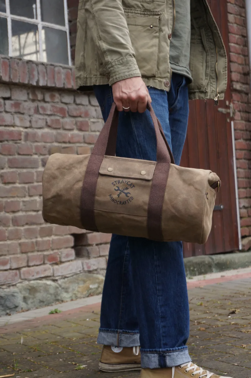 Duffle bag carried by hand, for scale.
