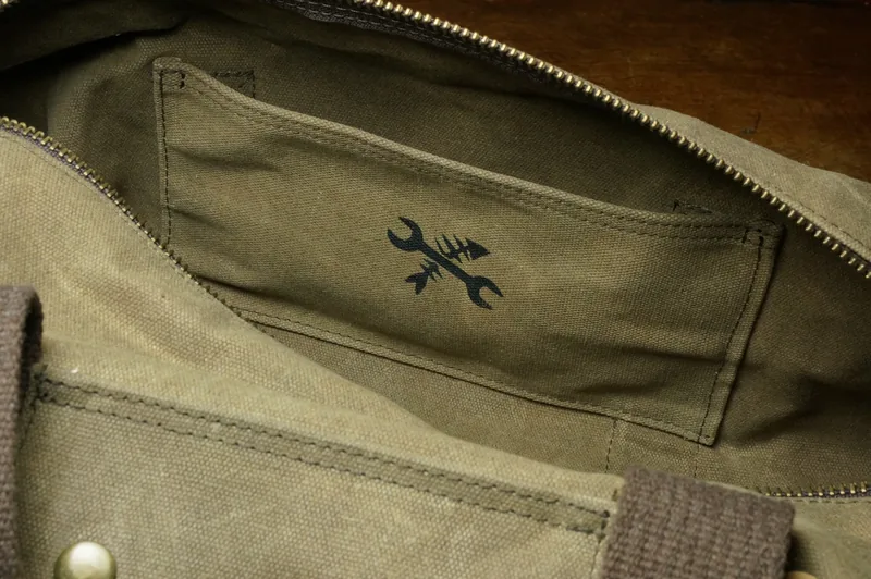 Inside view: inside pocket with logo and zip.