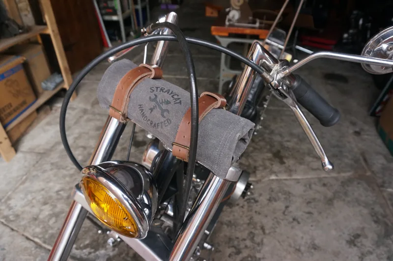 Tool Roll „Nine Lives“ in Storm Grey on a motorcycle handlebar.
