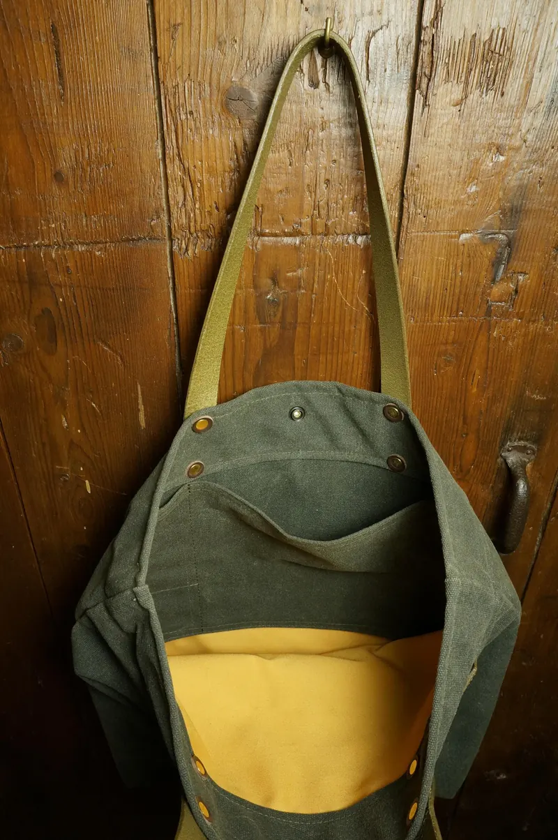 Open tote bag with yellow lining and inside pocket.