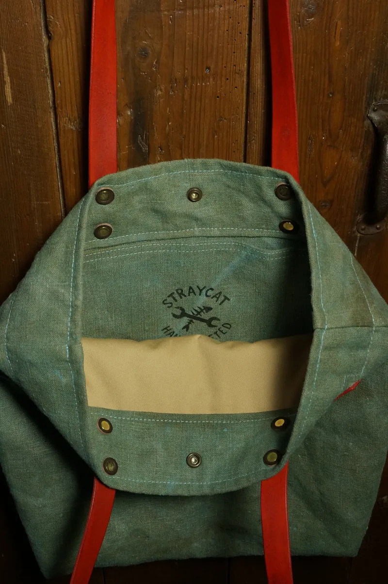 Open Tent Blue tote bag with red handles and logo on the inside.